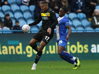 Daniel Adu-Adjei of Carlisle United challenges Toby Sibbick of Wigan Athletic during the FA Cup First Round match between Carlisle United an...