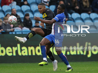 Daniel Adu-Adjei of Carlisle United challenges Toby Sibbick of Wigan Athletic during the FA Cup First Round match between Carlisle United an...