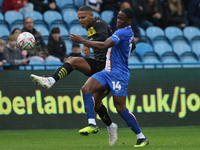 Daniel Adu-Adjei of Carlisle United challenges Toby Sibbick of Wigan Athletic during the FA Cup First Round match between Carlisle United an...