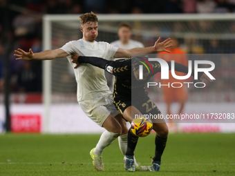 Tommy Conway of Middlesbrough challenges Joel Latibeaudiere of Coventry City during the Sky Bet Championship match between Middlesbrough and...