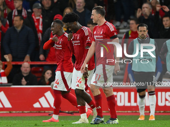 Goal scorers Callum Hudson-Odoi, Ola Aina, and Chris Wood of Nottingham Forest participate in the Premier League match between Nottingham Fo...