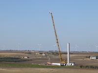 A large crane assembles a wind turbine in the rolling hills of Castelluccio dei Sauri, Foggia, Italy, on November 1, 2024. This wind farm ex...