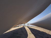 A large crane assembles a wind turbine in the rolling hills of Castelluccio dei Sauri, Foggia, Italy, on November 1, 2024. This wind farm ex...