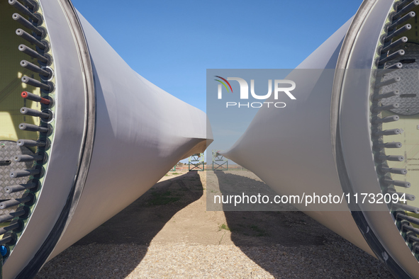 A large crane assembles a wind turbine in the rolling hills of Castelluccio dei Sauri, Foggia, Italy, on November 1, 2024. This wind farm ex...