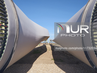 A large crane assembles a wind turbine in the rolling hills of Castelluccio dei Sauri, Foggia, Italy, on November 1, 2024. This wind farm ex...