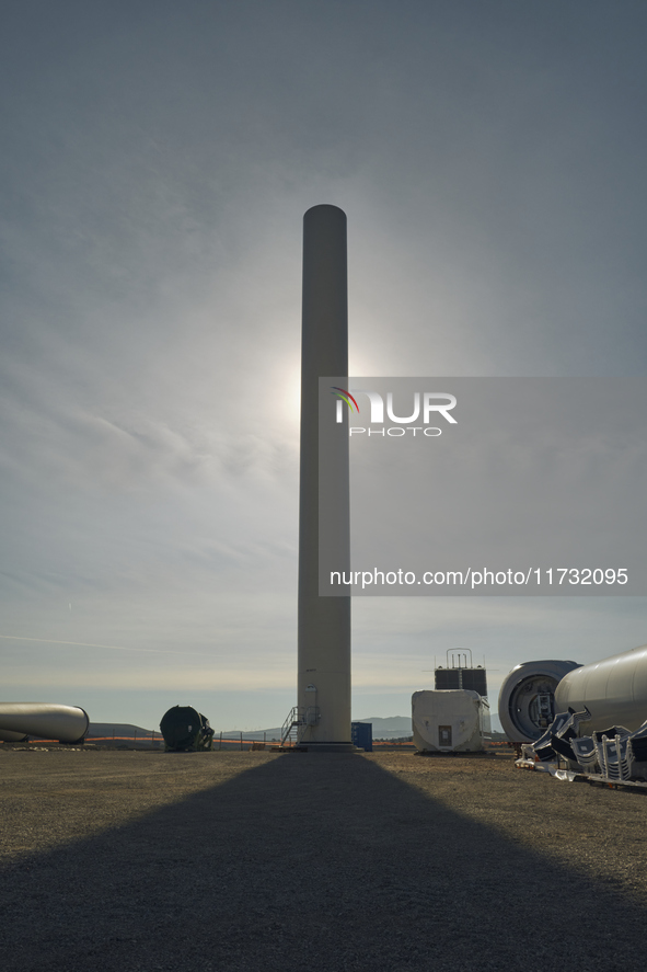 A large crane assembles a wind turbine in the rolling hills of Castelluccio dei Sauri, Foggia, Italy, on November 1, 2024. This wind farm ex...