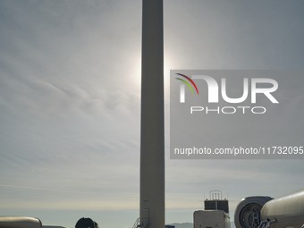 A large crane assembles a wind turbine in the rolling hills of Castelluccio dei Sauri, Foggia, Italy, on November 1, 2024. This wind farm ex...