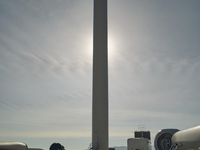 A large crane assembles a wind turbine in the rolling hills of Castelluccio dei Sauri, Foggia, Italy, on November 1, 2024. This wind farm ex...