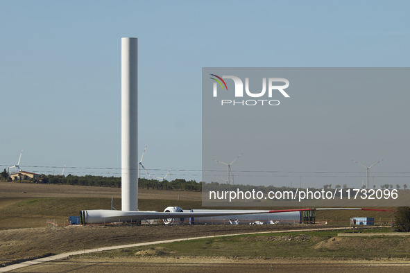 A large crane assembles a wind turbine in the rolling hills of Castelluccio dei Sauri, Foggia, Italy, on November 1, 2024. This wind farm ex...