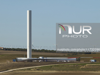 A large crane assembles a wind turbine in the rolling hills of Castelluccio dei Sauri, Foggia, Italy, on November 1, 2024. This wind farm ex...