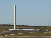 A large crane assembles a wind turbine in the rolling hills of Castelluccio dei Sauri, Foggia, Italy, on November 1, 2024. This wind farm ex...