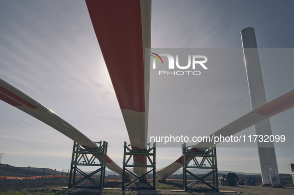 A large crane assembles a wind turbine in the rolling hills of Castelluccio dei Sauri, Foggia, Italy, on November 1, 2024. This wind farm ex...