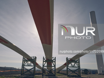 A large crane assembles a wind turbine in the rolling hills of Castelluccio dei Sauri, Foggia, Italy, on November 1, 2024. This wind farm ex...