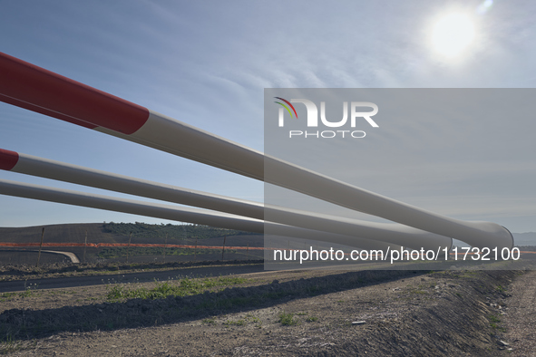 A large crane assembles a wind turbine in the rolling hills of Castelluccio dei Sauri, Foggia, Italy, on November 1, 2024. This wind farm ex...