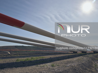 A large crane assembles a wind turbine in the rolling hills of Castelluccio dei Sauri, Foggia, Italy, on November 1, 2024. This wind farm ex...