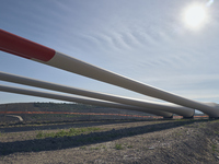 A large crane assembles a wind turbine in the rolling hills of Castelluccio dei Sauri, Foggia, Italy, on November 1, 2024. This wind farm ex...