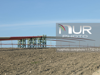 A large crane assembles a wind turbine in the rolling hills of Castelluccio dei Sauri, Foggia, Italy, on November 1, 2024. This wind farm ex...