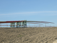 A large crane assembles a wind turbine in the rolling hills of Castelluccio dei Sauri, Foggia, Italy, on November 1, 2024. This wind farm ex...