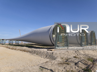 A large crane assembles a wind turbine in the rolling hills of Castelluccio dei Sauri, Foggia, Italy, on November 1, 2024. This wind farm ex...