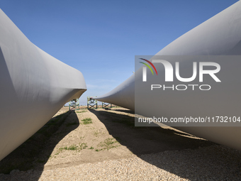 A large crane assembles a wind turbine in the rolling hills of Castelluccio dei Sauri, Foggia, Italy, on November 1, 2024. This wind farm ex...