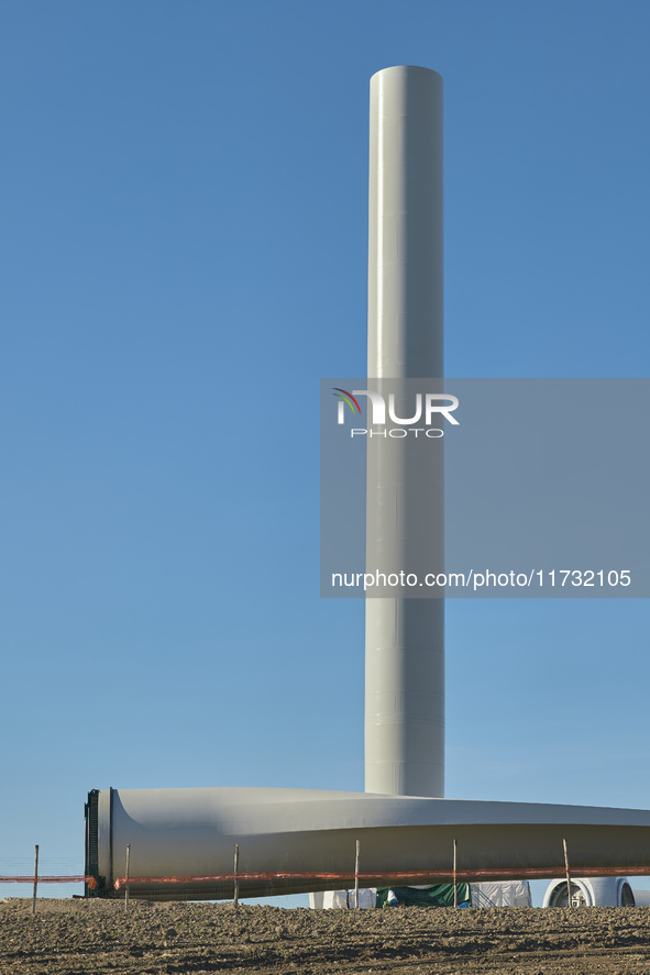 A large crane assembles a wind turbine in the rolling hills of Castelluccio dei Sauri, Foggia, Italy, on November 1, 2024. This wind farm ex...