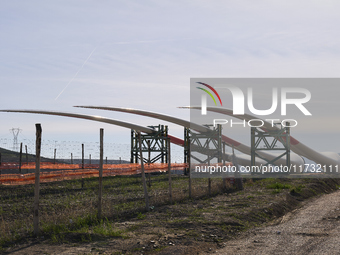 A large crane assembles a wind turbine in the rolling hills of Castelluccio dei Sauri, Foggia, Italy, on November 1, 2024. This wind farm ex...