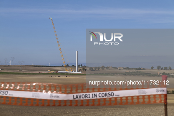 A large crane assembles a wind turbine in the rolling hills of Castelluccio dei Sauri, Foggia, Italy, on November 1, 2024. This wind farm ex...