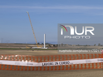 A large crane assembles a wind turbine in the rolling hills of Castelluccio dei Sauri, Foggia, Italy, on November 1, 2024. This wind farm ex...