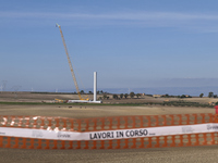 A large crane assembles a wind turbine in the rolling hills of Castelluccio dei Sauri, Foggia, Italy, on November 1, 2024. This wind farm ex...