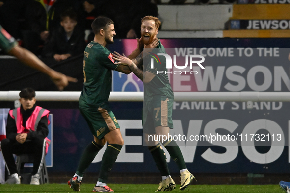 James Brophy (7, Cambridge United) celebrates after scoring the team's first goal during the FA Cup First Round match between Woking and Cam...