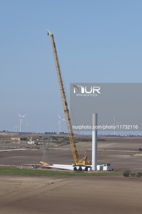 A large crane assembles a wind turbine in the rolling hills of Castelluccio dei Sauri, Foggia, Italy, on November 1, 2024. This wind farm ex...