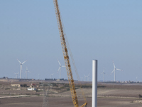 A large crane assembles a wind turbine in the rolling hills of Castelluccio dei Sauri, Foggia, Italy, on November 1, 2024. This wind farm ex...