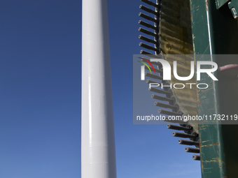 A large crane assembles a wind turbine in the rolling hills of Castelluccio dei Sauri, Foggia, Italy, on November 1, 2024. This wind farm ex...