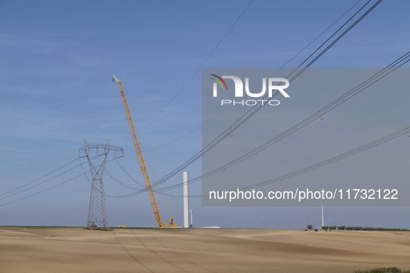 A large crane assembles a wind turbine in the rolling hills of Castelluccio dei Sauri, Foggia, Italy, on November 1, 2024. This wind farm ex...