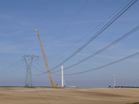 A large crane assembles a wind turbine in the rolling hills of Castelluccio dei Sauri, Foggia, Italy, on November 1, 2024. This wind farm ex...