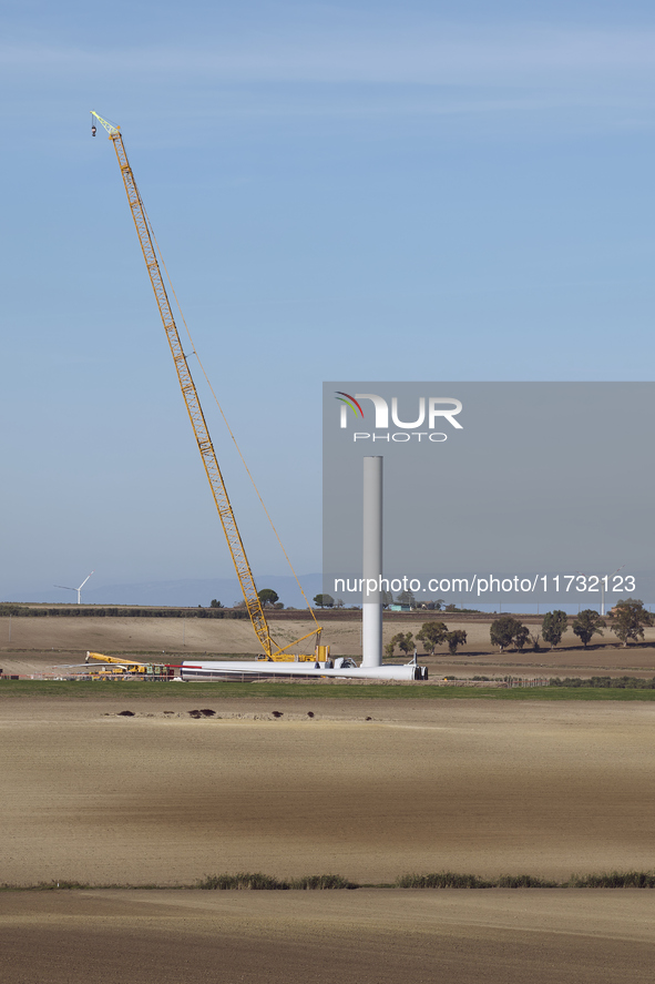 A large crane assembles a wind turbine in the rolling hills of Castelluccio dei Sauri, Foggia, Italy, on November 1, 2024. This wind farm ex...