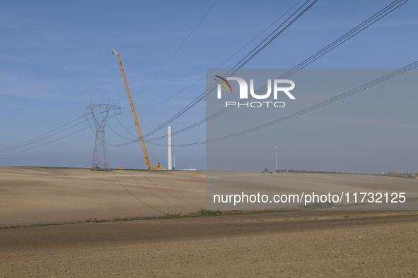 A large crane assembles a wind turbine in the rolling hills of Castelluccio dei Sauri, Foggia, Italy, on November 1, 2024. This wind farm ex...