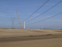 A large crane assembles a wind turbine in the rolling hills of Castelluccio dei Sauri, Foggia, Italy, on November 1, 2024. This wind farm ex...