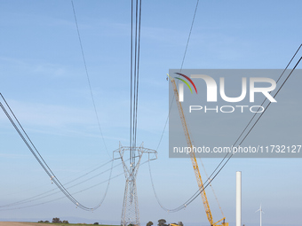 A large crane assembles a wind turbine in the rolling hills of Castelluccio dei Sauri, Foggia, Italy, on November 1, 2024. This wind farm ex...