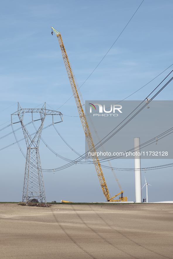 A large crane assembles a wind turbine in the rolling hills of Castelluccio dei Sauri, Foggia, Italy, on November 1, 2024. This wind farm ex...