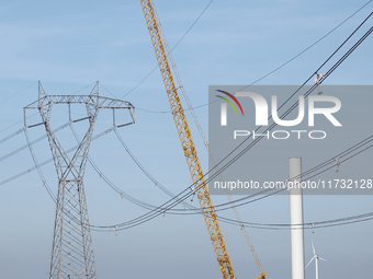 A large crane assembles a wind turbine in the rolling hills of Castelluccio dei Sauri, Foggia, Italy, on November 1, 2024. This wind farm ex...