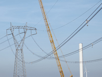 A large crane assembles a wind turbine in the rolling hills of Castelluccio dei Sauri, Foggia, Italy, on November 1, 2024. This wind farm ex...