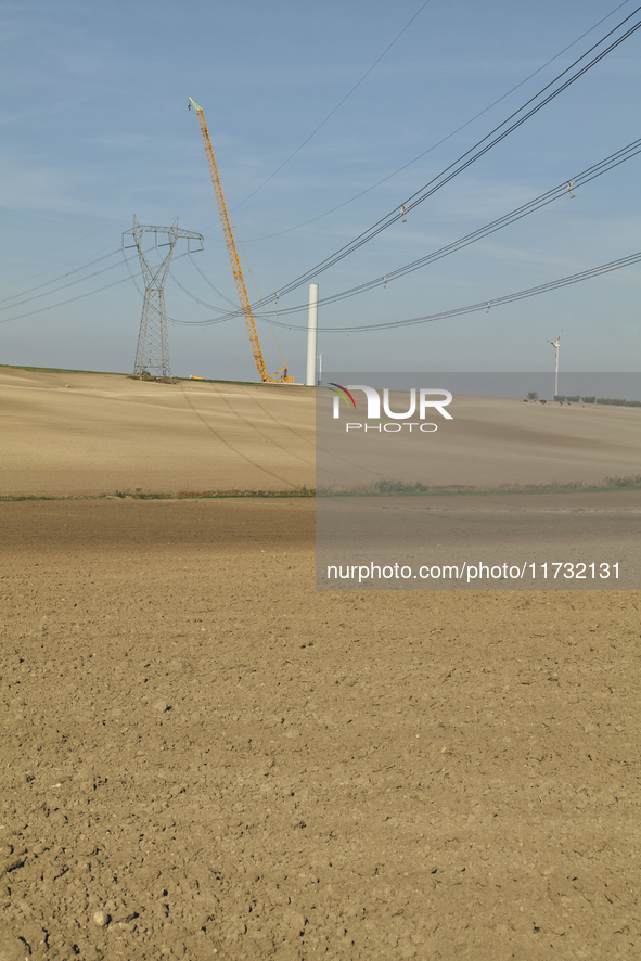 A large crane assembles a wind turbine in the rolling hills of Castelluccio dei Sauri, Foggia, Italy, on November 1, 2024. This wind farm ex...