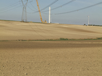 A large crane assembles a wind turbine in the rolling hills of Castelluccio dei Sauri, Foggia, Italy, on November 1, 2024. This wind farm ex...