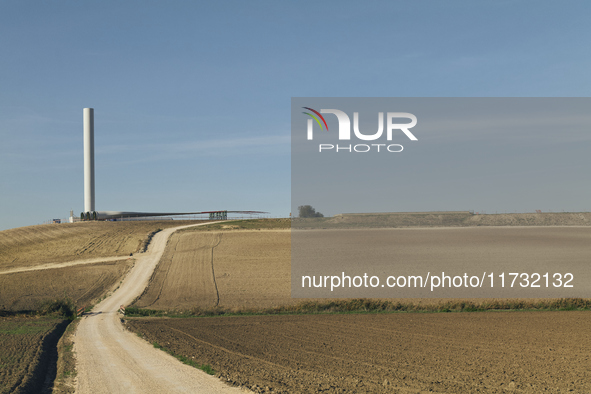 A large crane assembles a wind turbine in the rolling hills of Castelluccio dei Sauri, Foggia, Italy, on November 1, 2024. This wind farm ex...