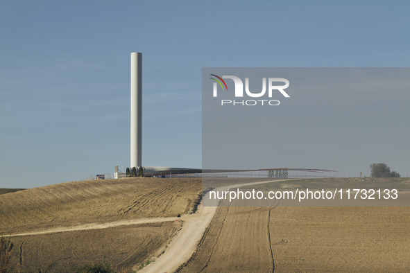 A large crane assembles a wind turbine in the rolling hills of Castelluccio dei Sauri, Foggia, Italy, on November 1, 2024. This wind farm ex...