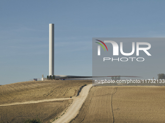 A large crane assembles a wind turbine in the rolling hills of Castelluccio dei Sauri, Foggia, Italy, on November 1, 2024. This wind farm ex...