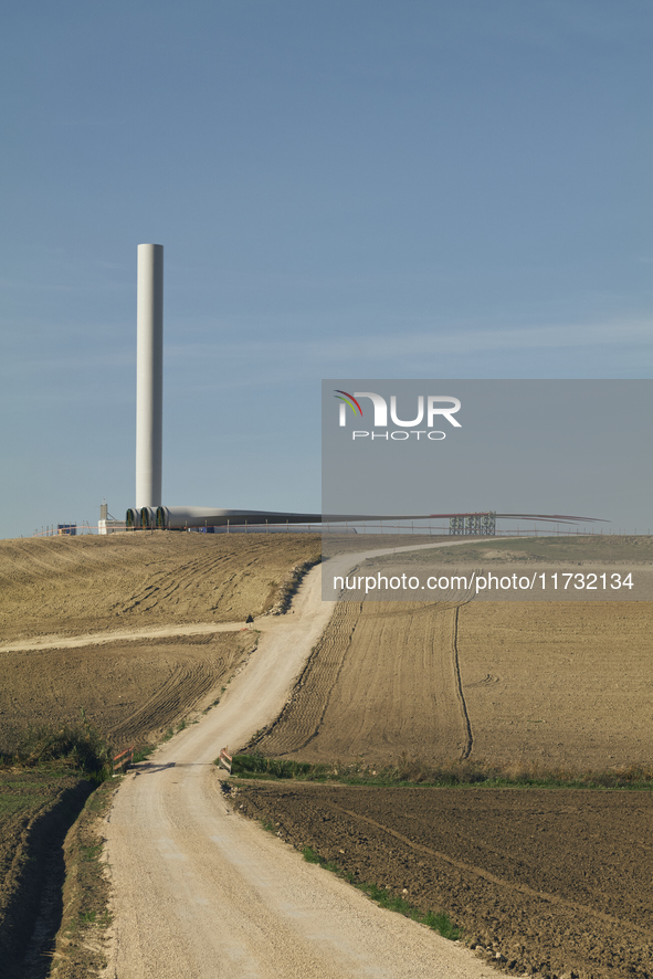 A large crane assembles a wind turbine in the rolling hills of Castelluccio dei Sauri, Foggia, Italy, on November 1, 2024. This wind farm ex...