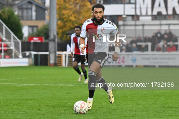 Deon Moore (14 Woking) controls the ball during the FA Cup First Round match between Woking and Cambridge United at the Kingfield Stadium in...