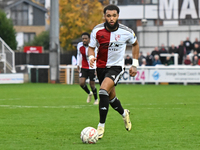 Deon Moore (14 Woking) controls the ball during the FA Cup First Round match between Woking and Cambridge United at the Kingfield Stadium in...